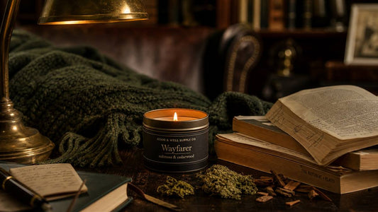 Wayfarer Field Candle in a dark academia home study with oakmoss, cedarwood, books, and candlelight